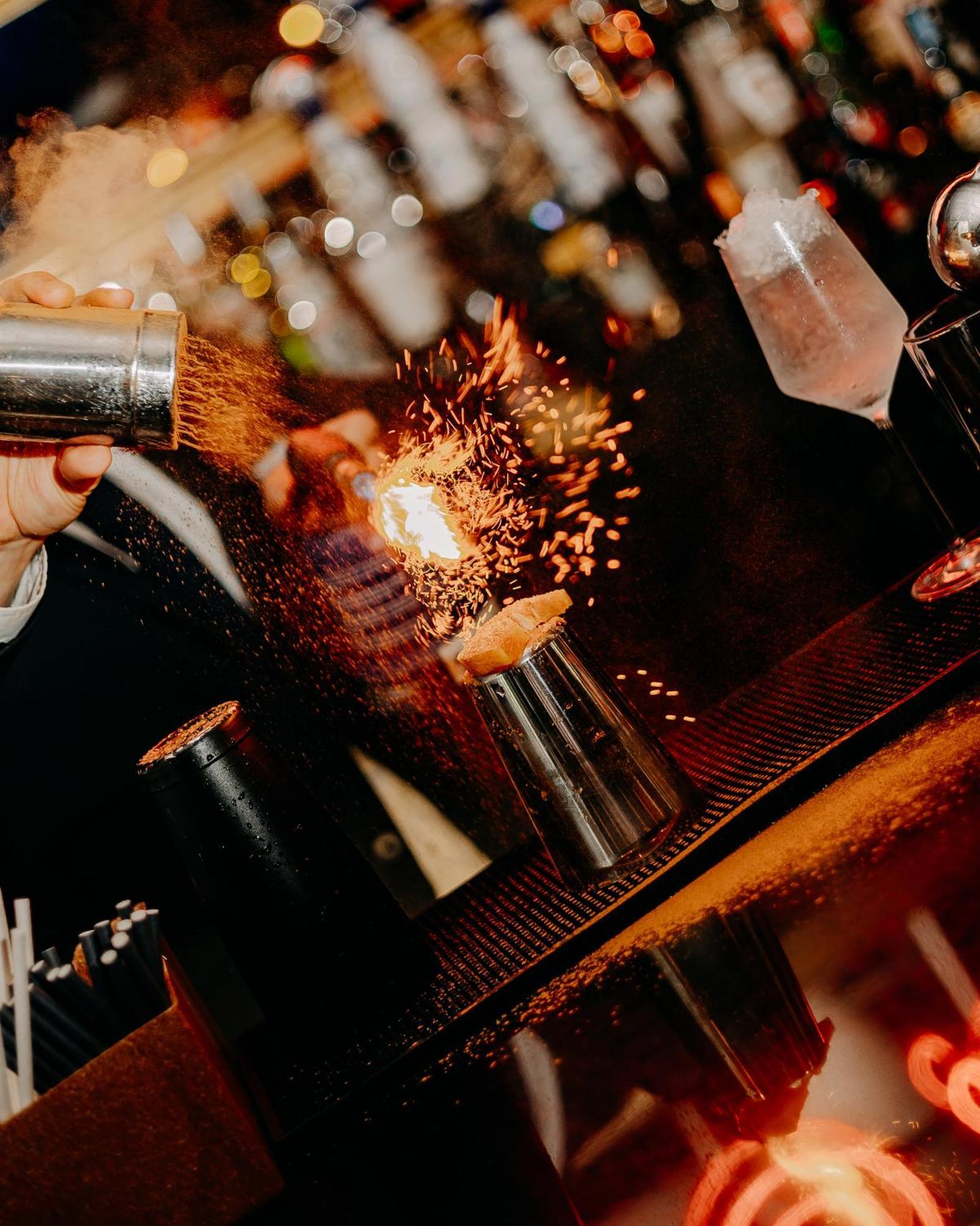 138 Liberdade Hotel 리스본 외부 사진 A bartender using a cocktail gun to make a flaming shot